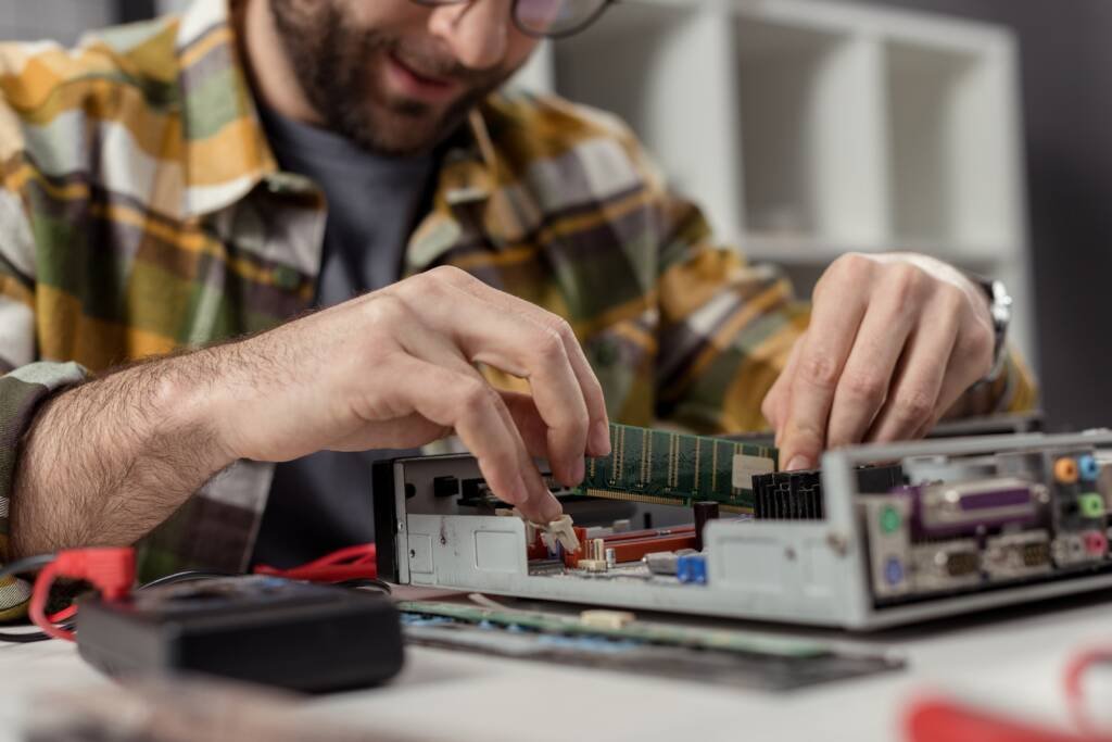 caucasian man reapairing repairing computer